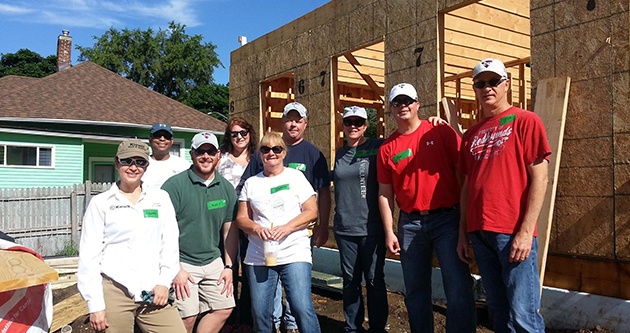 3CU's team works collaboratively on a community development project building homes.